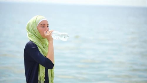 Muslim Girl Drinking Water After Workout Outdoor