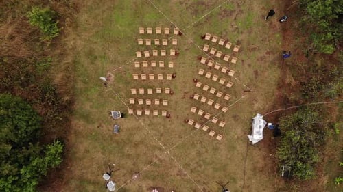 Top View of Wedding Ceremony Venue with Rows of Chairs for Guests and Flower Arch in Nature