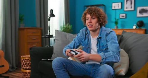Teenager Playing Video Game at Home