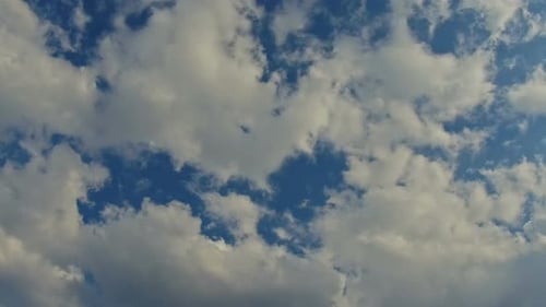 Clouds Drifting Across a Clear Blue Sky