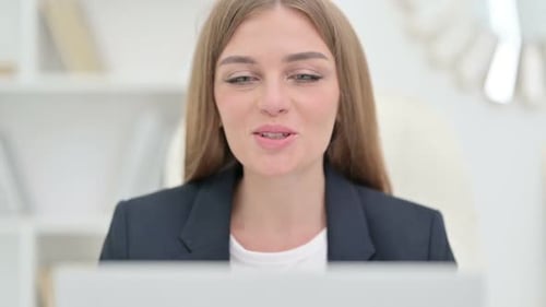 Woman Smiling and Waving on Video Call
