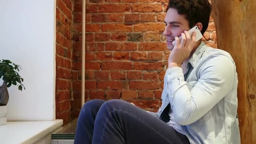 Man Talking on Mobile Phone Attending Call Loft Interior