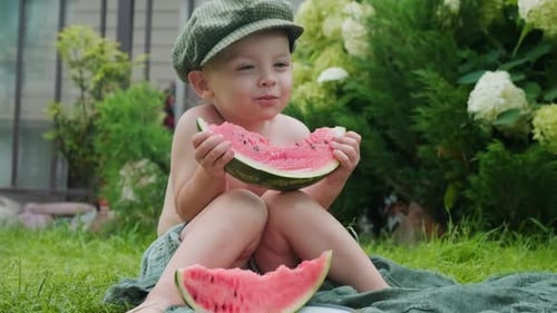 Adorable Child Enjoys Fresh Watermelon Outdoors