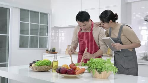 Couple Making Healthy Salad in Modern Kitchen