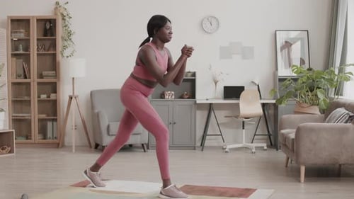 Young African-American Sportswoman Having Home Training