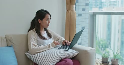 Woman Working on Laptop in Apartment