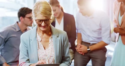 Woman Smiling, Using Tablet at Workplace with Team