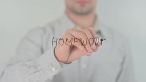 Man Writing Homework on a Clear Surface