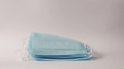 Stack of New, Light Blue Surgical Masks