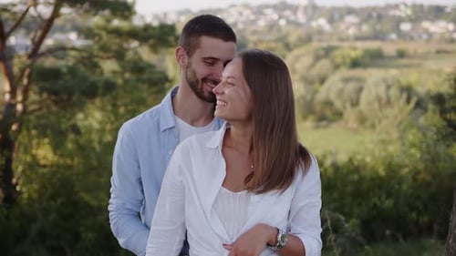 Closeup of a Beautiful Girl and Boy Hugging in a Park