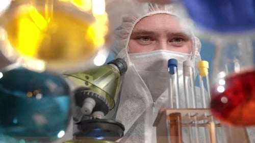 Researcher Looks Through Microscope in Lab Environment