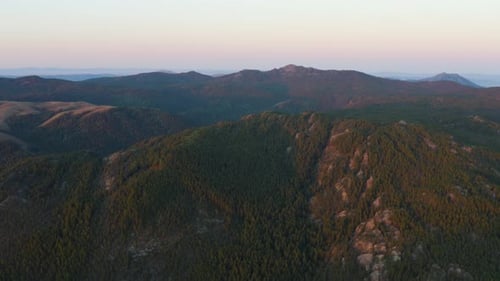 Aerial View of Forested Mountain Range at Sunrise