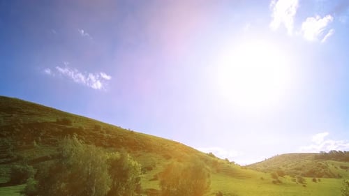 UHD Mountain Meadow Timelapse at the Summer. Clouds, Trees, Green Grass and Sun Rays Movement.