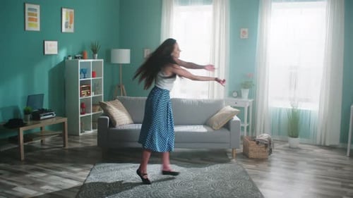 Woman Dancing Gracefully in Bright Living Room
