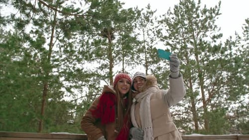 Friends Taking Selfie in Snowy Winter Wonderland