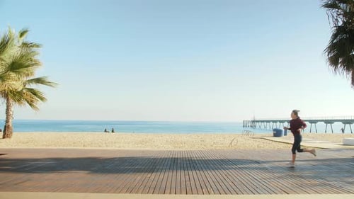 Young Woman Running on Beach Exercising Cardio Workout Training