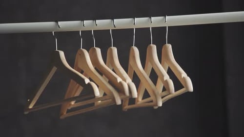 Minimalist Wooden Hangers on a Wardrobe Rail