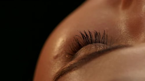 Applying Black Mascara in Extreme Close Up