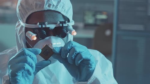 Scientist Examining Computer Chip in Laboratory