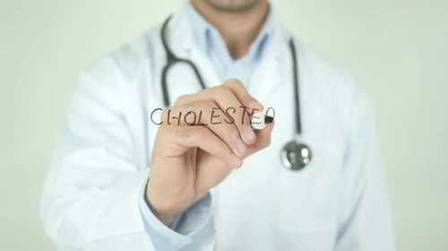Doctor Writing Cholesterol on Clear Surface