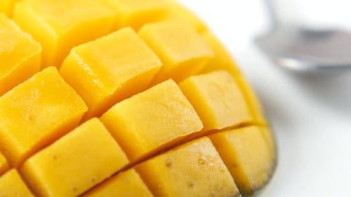 Yellow Ripe Cut Mango on White Background