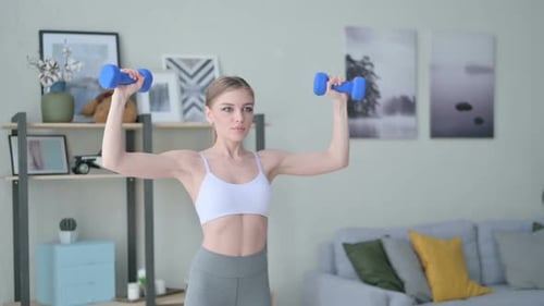 Sporty Woman Doing Overhead Dumbbell Press Indoors
