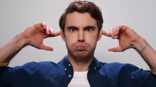 Handsome Man Making Funny Faces, Male Model Making Grimaces in Studio