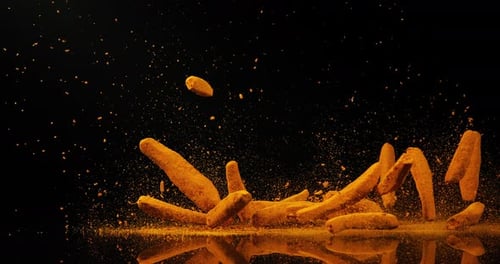 Falling Golden Sticks on Black Reflective Surface
