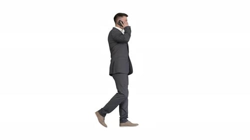 Man in Suit Walking and Talking on Cellphone