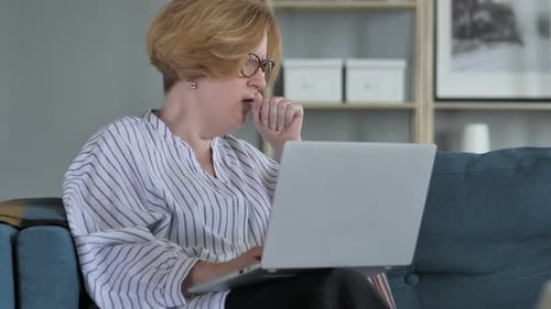 Woman Coughing While Using Laptop at Home
