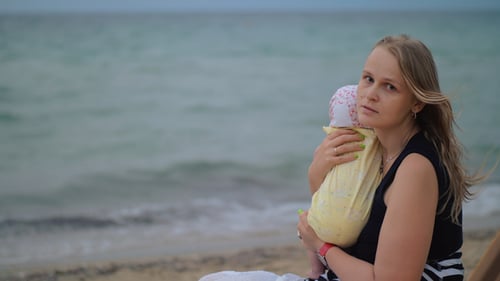 Sad Mum with Baby Near the Sea