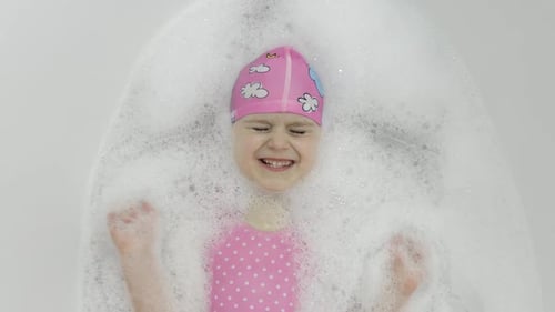 Child Smiling in a Bubble Bath
