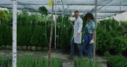 Gardeners Walking in Nursery Garden