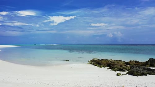 Daytime above abstract shot of a white paradise beach and blue water background in colourful 4K