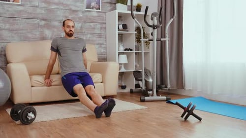 Man Doing Tricep Dips on Couch in Living Room