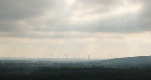 Wind Turbines in Rural Landscape with Cloudy Sky