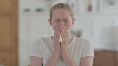 Woman Sneezes into Tissue due to Illness