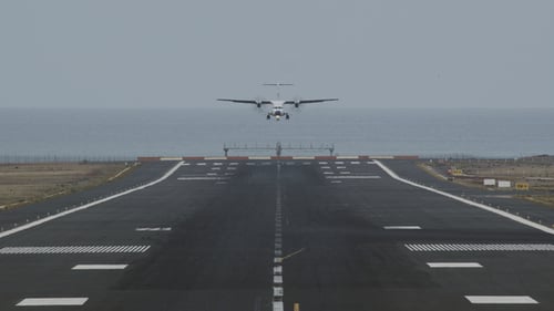 An Airport Runway with a Landing Plane