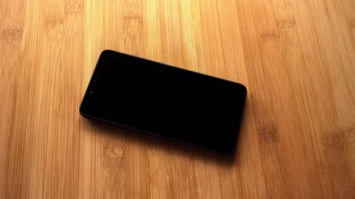 Close up of cell phone on a wooden table