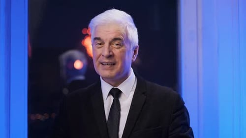 Mature Adult Takes Off Mask and Gives Thumbs Up