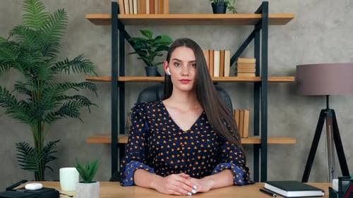 Calm businesswoman in home office looks camera listen interlocutor top manager report video call