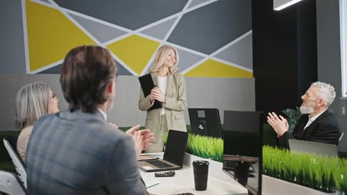Business Team Applauding Blond Woman in Office