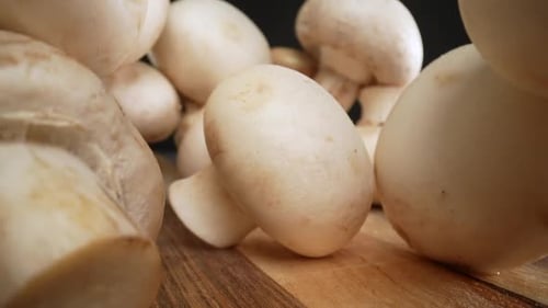 Close-up of White Button Mushrooms on Wood Table