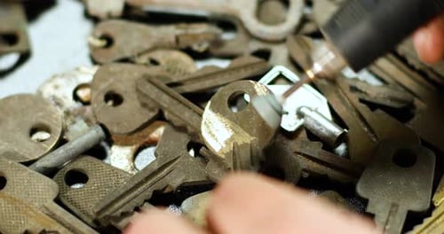 Locksmith in workshop makes new key, use grinding engraving machine