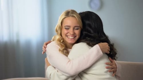 Young Women Embracing in a Home Setting