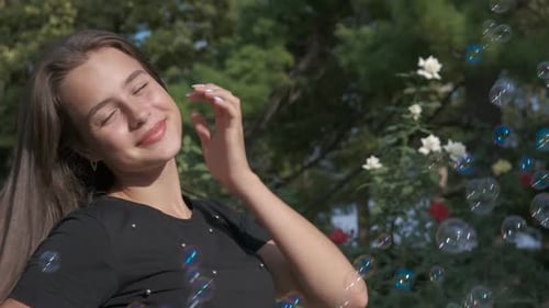 Smiling Woman with Bubbles in Sunny Park