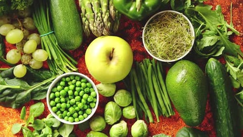 Fresh Green Vegetables and Fruits Assortment Placed on a Rusty Metal