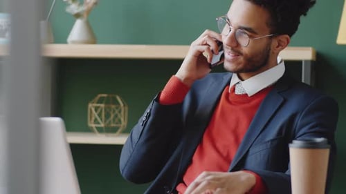 Young Mixed Race Businessman Talking on Phone in Office