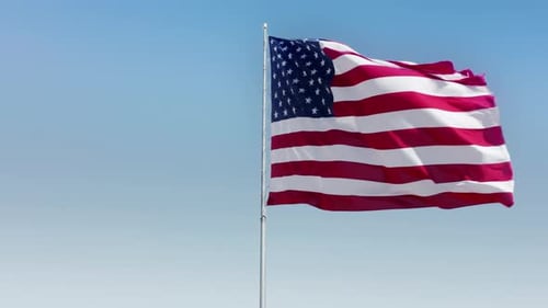 American Flag Waving Proudly Against a Blue Sky