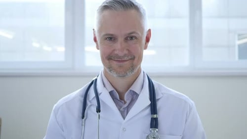 Smiling Doctor with Stethoscope Wearing a White Coat